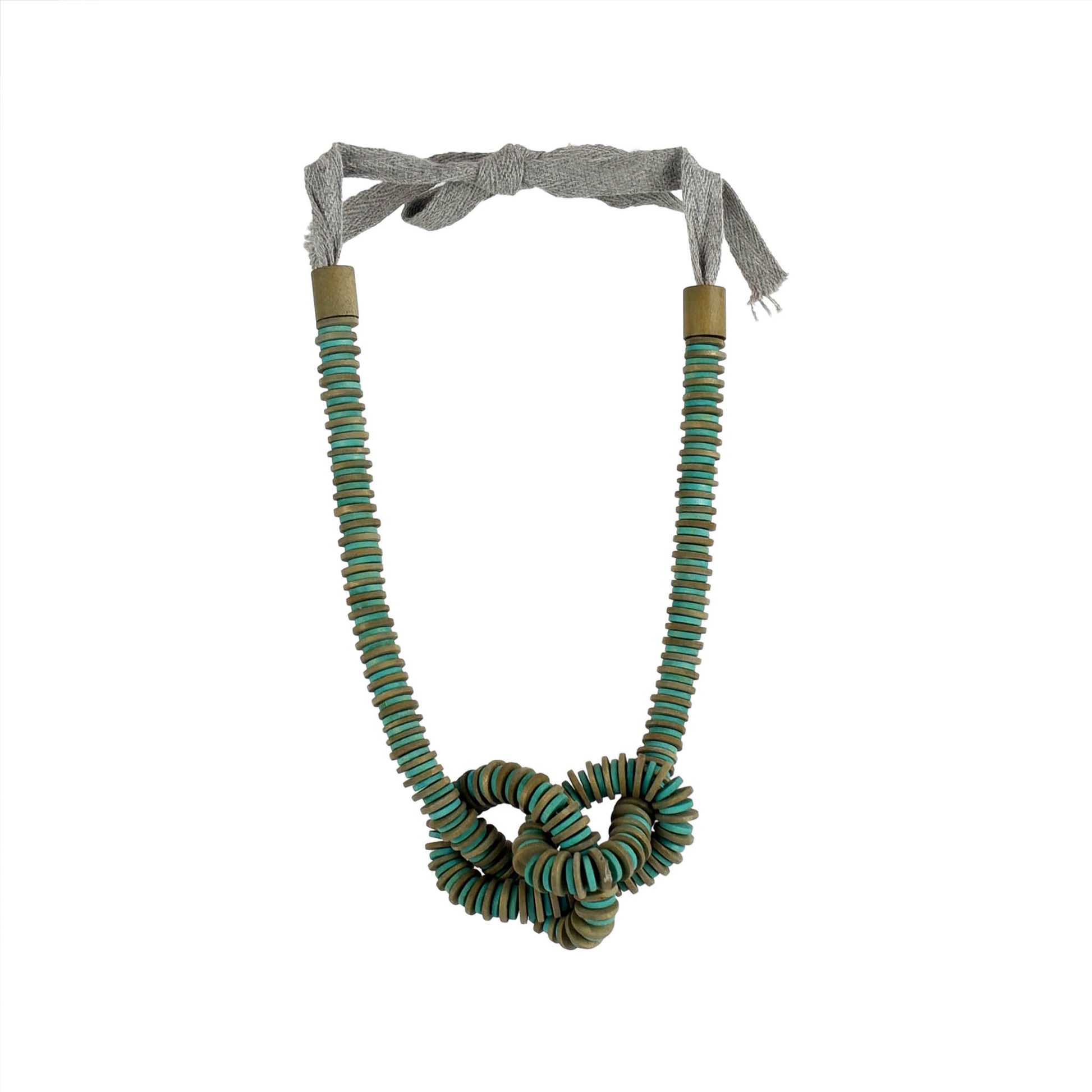 Handmade green wooden necklace featuring a knotted pendant and grosgrain ribbon neckline. Ethically crafted by a sustainable fashion accessories manufacturer.

