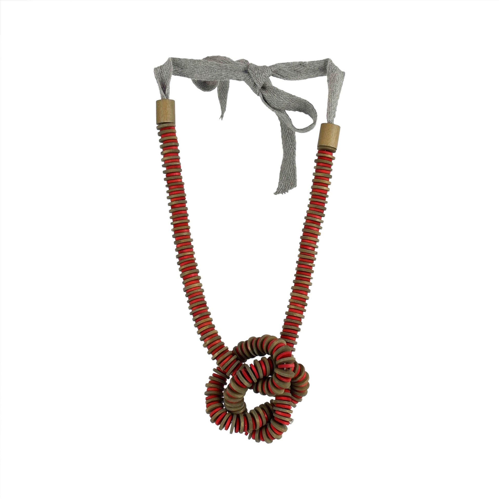 Handmade red wooden necklace featuring a knotted pendant and grosgrain ribbon neckline. Ethically crafted by a sustainable fashion accessories manufacturer.

