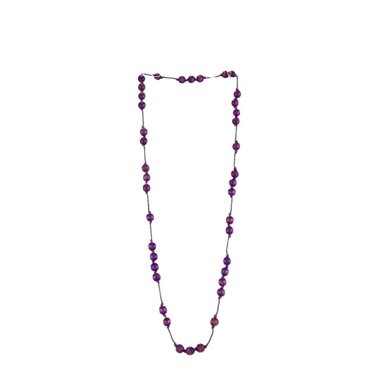 Handmade purple wooden necklace featuring round beads strung along a fine cord. A unique, eco-friendly, artisan-crafted minimalist jewelry piece.